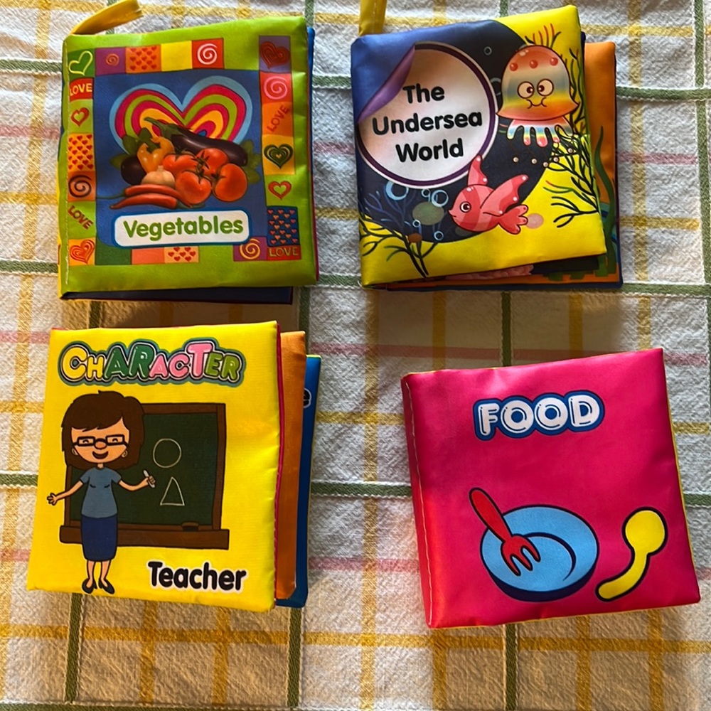 4 baby soft sensory books and a soft bracelet rattle Velcro